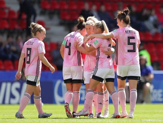 Scotland squad celebrate after Lana Clelland pulls a goal back in the defeat to Japan.