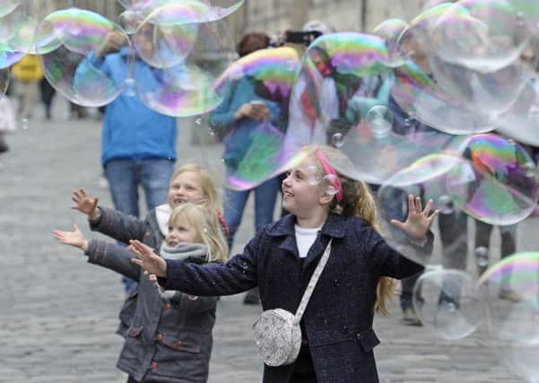 Fun with bubbles during one of the city's open streets events. Picture: Neil Hanna