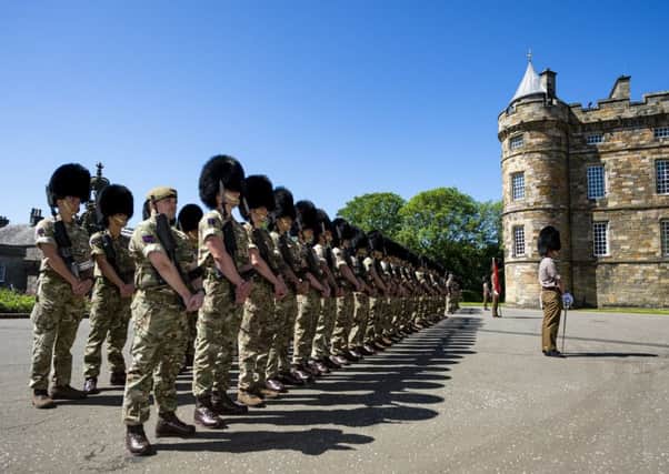 Scots Guards prepare to welcome the Queen.