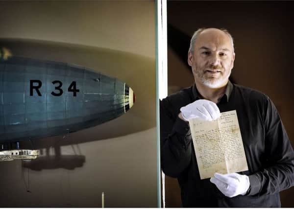 Ian Brown, Assistant Curator of Aviation at the National Museum of Flight, East Fortune, holds a letter written 100 years ago and dropped over Nova Scotia from the R.34 airship during its record-breaking double transatlantic crossing in 1919.