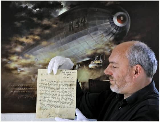 Ian Brown, Assistant Curator, Aviation at the National Museum of Flight,  holds a letter written 100 years ago and dropped over Nova Scotia from the R34 airship during its record-breaking double transatlantic crossing in 1919.
