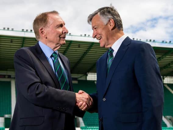 Sir Tom Farmer shakes hands with Ron Gordon after the latter's takeover of the club was announced.