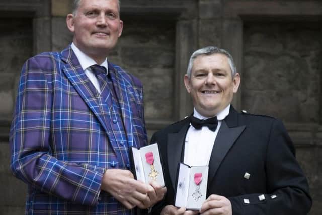 Former Scotland Rugby international and Motor Neurone campaigner Doddie Weir (left) after receiving his OBE and Tourette's Syndrome campaigner John Davidson after receiving his MBE from Queen Elizabeth II