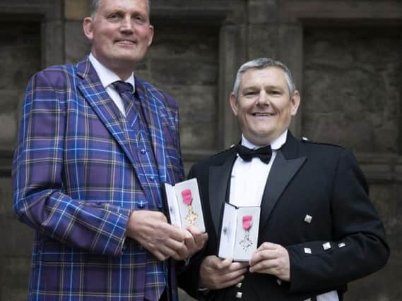 Former Scotland Rugby international and Motor Neurone campaigner Doddie Weir (left) after receiving his OBE and Tourette's Syndrome campaigner John Davidson after receiving his MBE from Queen Elizabeth II