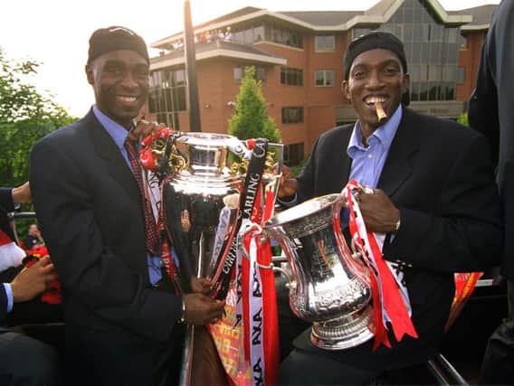 Dwight Yorke, right, with Andy Cole, celebrates Manchester United's 1999 Treble