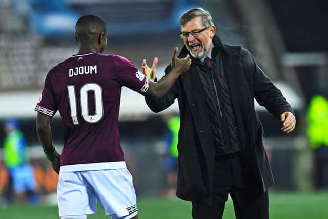 Hearts boss Craig Levein alongside Arnaud Djoum