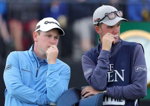 Bob MacIntyre (left) speaks to his caddy whose muother was hit by one of  Kyle Stanley's wayward shots