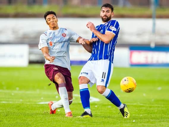 Hearts' Sean Clare battles for possession with Kris Renton.