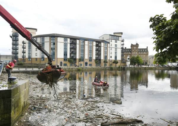 The litter squad has been deployed at Leith Shore to begin the clean-up operation. Picture: Neil Hanna