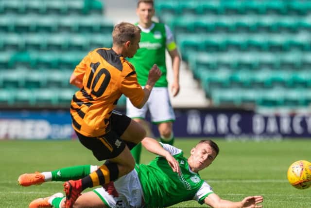 Hibs kid Josh Campbell slides in to win the ball off Alloa's Alan Trouten
