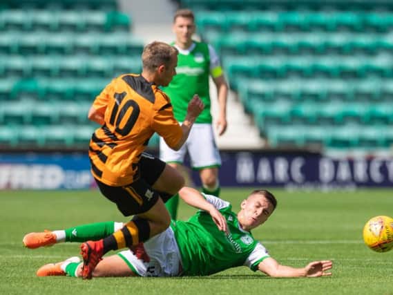 Hibs kid Josh Campbell slides in to win the ball off Alloa's Alan Trouten