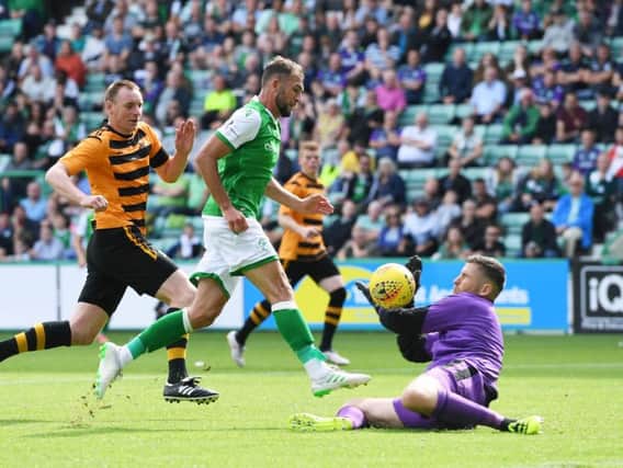 Christian Doidge chips the ball over the onrushing Alloa 'keeper Neil Parry to net Hibs' first goal