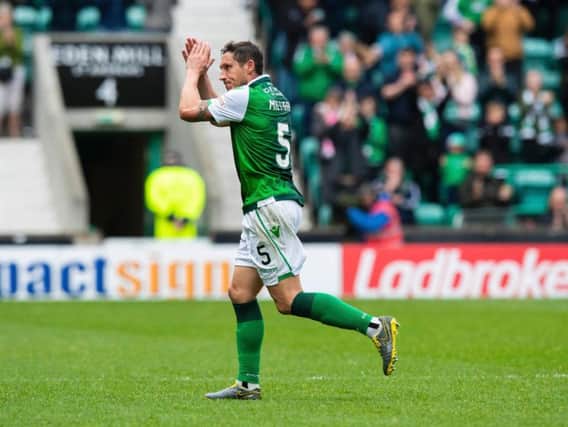 Mark Milligan applauds the fans as he is substituted in his final appearance for Hibs