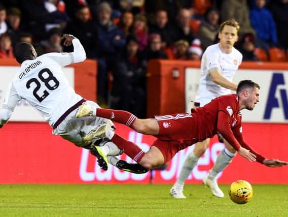 Clevid Dikamona gets stuck in during Hearts' last trip to Pittodrie