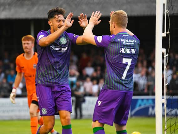 Joe Newell, left, celebrates with Daryl Horgan after opening the scoring for Hibs away at Elgin City. Pic: SNS