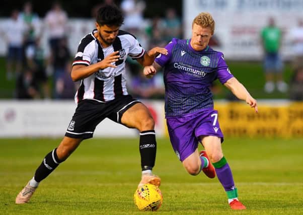Hibs' Daryl Horgan challenges Rabin Omar of Elgin City during their Betfred Cup clash. Pic: SNS