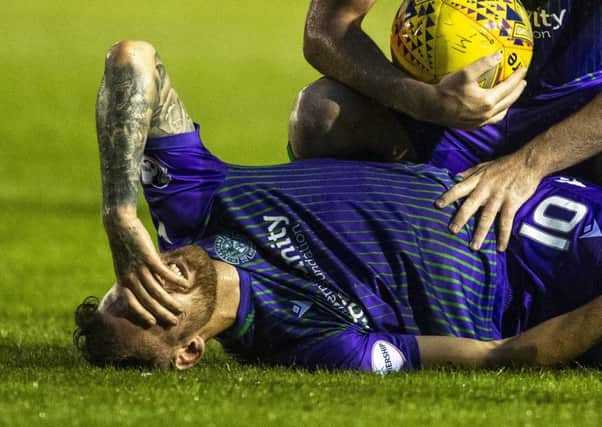 Martin Boyle in pain after going down against Elgin City because of a problem in his left knee
