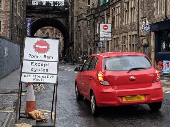 Photos have emerged of cars using the Cowgate despite controls in place  some show police vehicles using the busy thoroughfare.