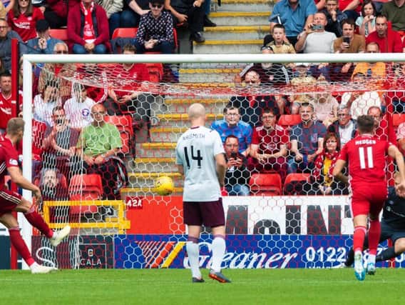 Sam Cosgrove scores a penalty to bring Aberdeen level with Hearts at 2-2.