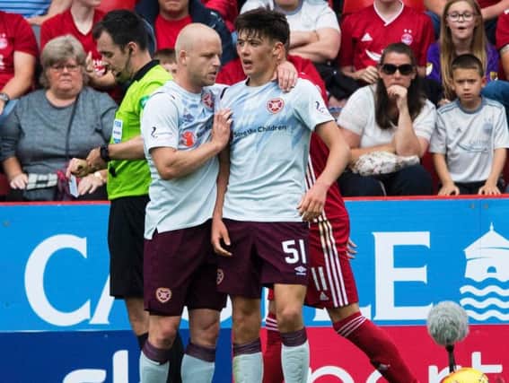 Steven Naismith commiserates Aaron Hickey after his red card.