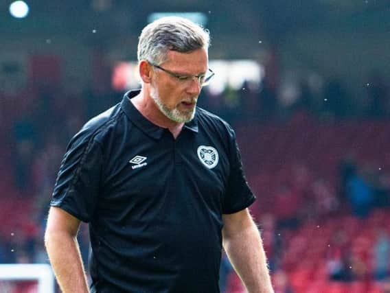 Craig Levein cuts a dejected figure as he walks off the Pittodrie pitch at full time