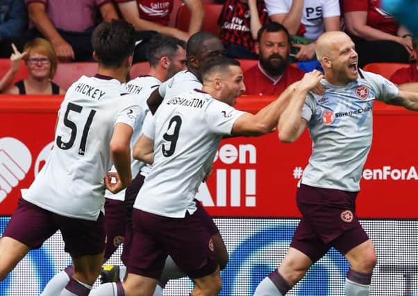 Steven Naismith wheels away in delight after equalising for Hearts. Picture: SNS Group