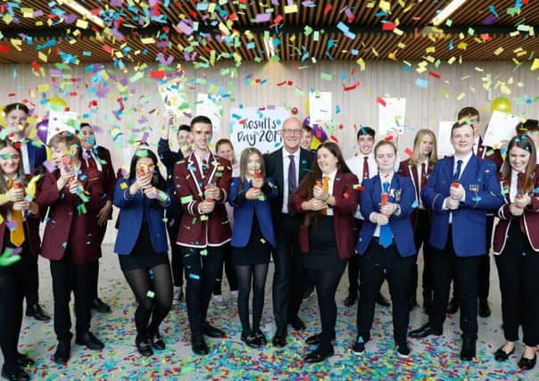 Scottish Education Secretary John Swinney with celebrating school pupils. Picture: PA