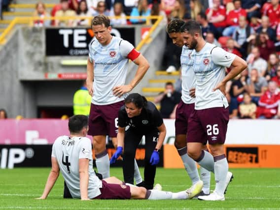 Hearts defender John Souttar receives treatment after injuring his ankle at Pittodrie