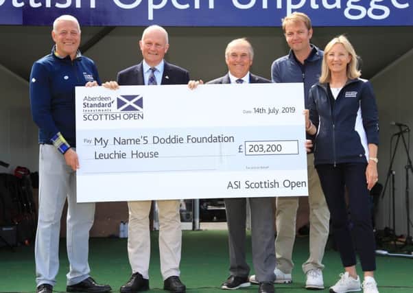 The handover of the cheque for the official charity during the final round of the Aberdeen Standard Investments Scottish Open at The Renaissance Club in July. Pic: SNS