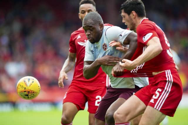Hearts' Uche Ikpeazu fends off Aberdeen defenders during the 3-2 defeat. Pic: SNS