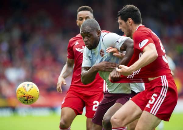 Hearts' Uche Ikpeazu fends off Aberdeen defenders during the 3-2 defeat. Pic: SNS