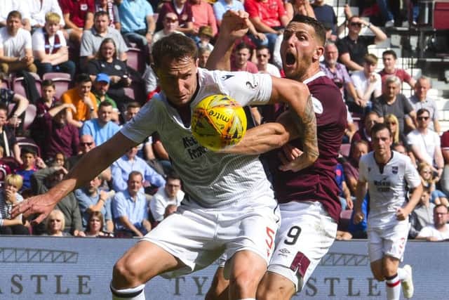 Hearts' Conor Washington battles with Ross County's Callum Morris. Pic: SNS