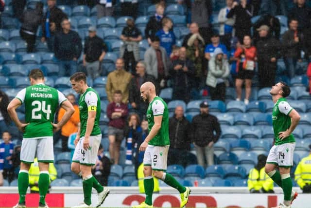 Hibs players hang their heads after the 6-1 thumping at Ibrox. Picture: SNS