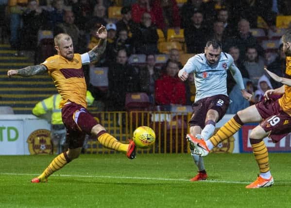 Michael Smith drills the ball home to put Hearts ahead at Fir Park. Pic: SNS