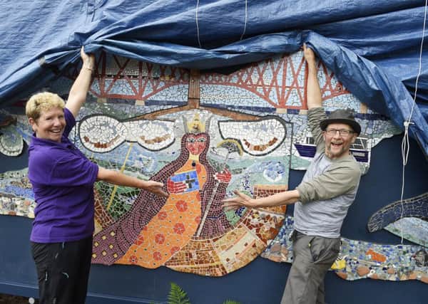 Iona Chandler (chair of Green Free Trust) and Mike Spring (Mural Designer) give a sneak look at the 14.2m mural which has been installed in the revamped Hawthorn Bank Community Garden. Picture: Greg Macvean