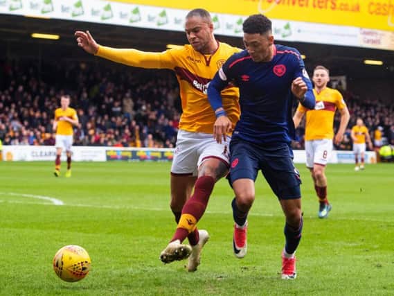 Charles Dunne and Sean Clare battle for possession the last time Hearts faced Motherwell at Fir Park.