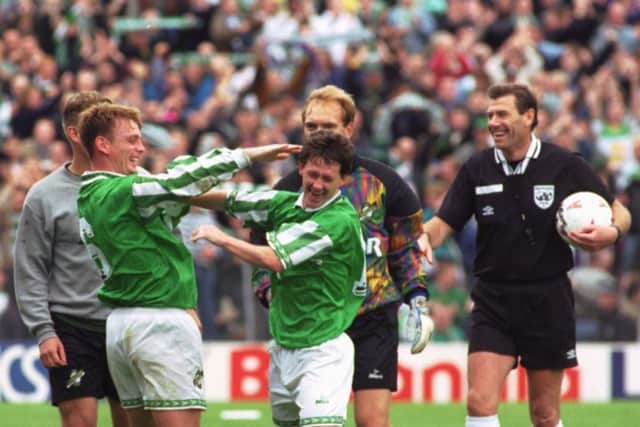 The referee laughs as Gordon Hunter, team captain, and team-mate Kevin McAllister celebrate victory fr Hibernian over Hearts
