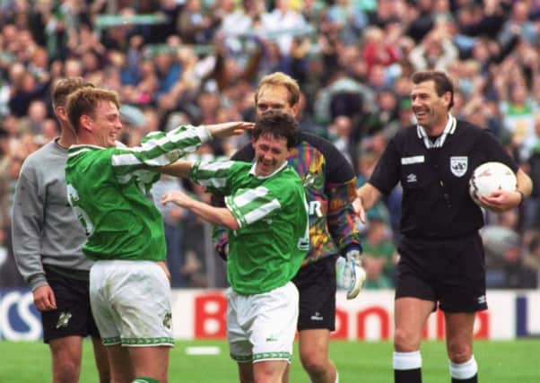 The referee laughs as Gordon Hunter, team captain, and team-mate Kevin McAllister celebrate victory fr Hibernian over Hearts
