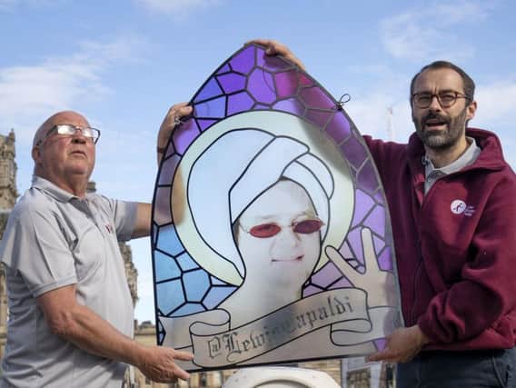 Centre manager Peter Law (right) and his assistant Malcolm Moore take a closer look at a stain-glass window that features Scottish singer-songwriter Lewis Capaldi. The window will be on display in the Scottish Twitter Visitor Centre at the Edinburgh Fringe.