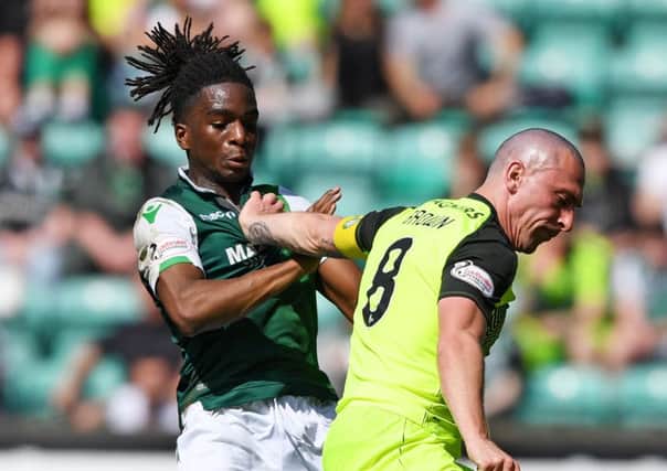 Hibs' Stephane Omeonga challenges Scott Brown of Celtic last season. Pic: SNS