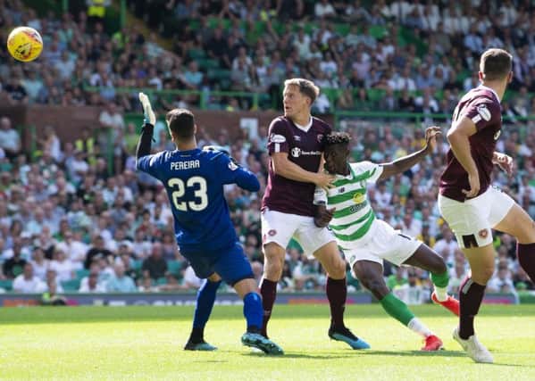 A combination of Hearts defender Christophe Berra and Celtic striker Vikoun Bayo combine to open the scoring for the hosts. Pic: SNS