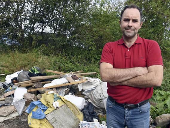 Robin Traquair next to the latest pile of waste