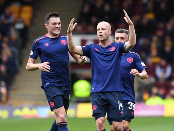 John Souttar (left) and Steven Naismith in action for Hearts last season. The pair are nearing a comeback for Hearts