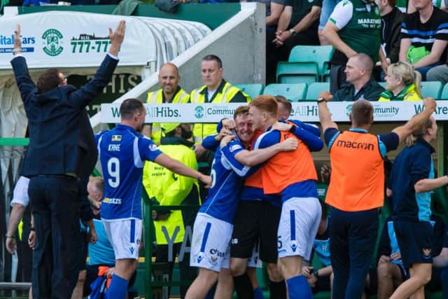 Tommy Wright celebrates in front of the Hibs support. Picture: SNS