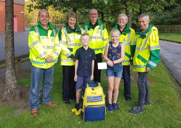 Sophie and Glen with Penicuik Community First Responders from left to right : Bill Lawson, Yvonne Mitchell, Alan Dickson,  Gilbert Kirkwood and Douglas Wilson.