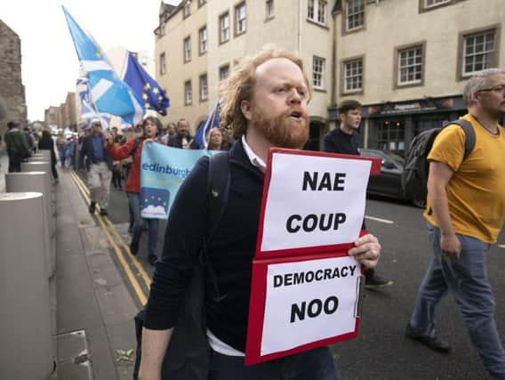 Protesters from the European Movement in Scotland march on the High Street in Edinburgh