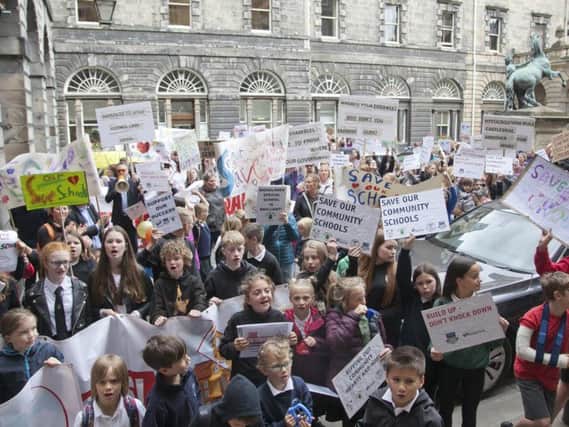 Parents demonstrated outside the City Chambers as part of their campaign to save Currie High School.