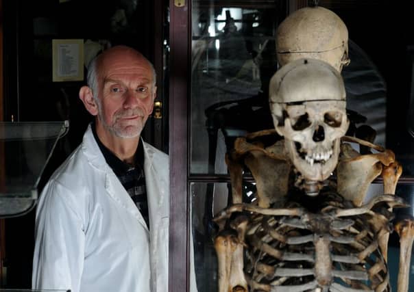 Dr Gordon Findlater of Edinburgh University's Medical School with masks and the skeleton of William Burke inside the Medical School's Museum.
Pic Neil Hanna