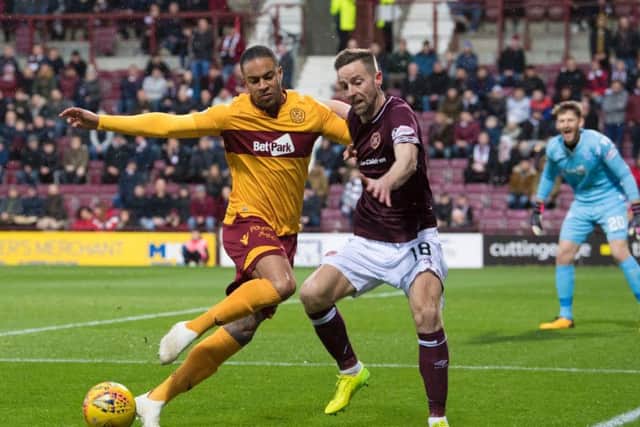 Motherwell's Charles Dunne and Steven MacLean battle for possession.