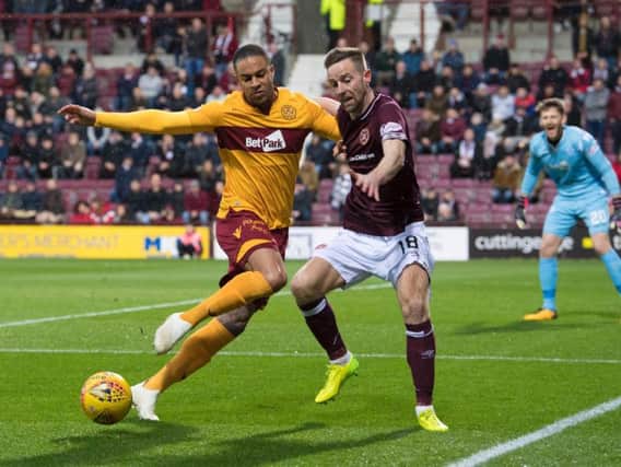 Motherwell's Charles Dunne and Steven MacLean battle for possession.